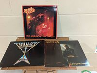 Front covers of the three vinyl LP albums displayed upright and flat to show artwork details.