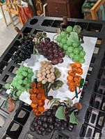 Overhead shot of eight glass grape clusters on white background