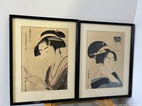 Pair of framed Japanese woodblock prints side by side, showing full images and frames