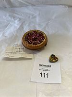 Photo of Limoges tart-shaped porcelain box with red fruit decoration and a tag with details and auction info, plus a small heart-shaped box and MaxSold lot card.