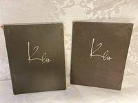 Two hardcover portfolios with brown covers featuring 'Klee' embossed in stylized script.