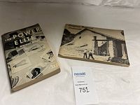 Two vintage paperback books placed side by side on a cloth surface, one titled "The Power Elite" and the other "California Redwood Landscape Architecture."