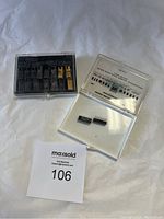 Full lot showing multiple integrated circuit chips in plastic storage boxes on a white background.