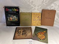 Image showing six vintage books arranged on a table including Snow-White by the Brothers Grimm and others.
