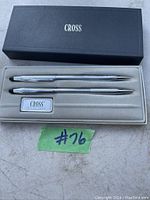 Pair of silver-tone Cross pens, ballpoint pen and mechanical pencil, in original black Cross box with grey fabric interior.