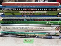 Stack of 14 children's books showing titles and authors/spine details