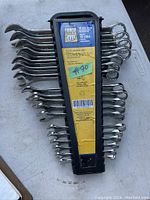 Lot of 19 combination wrenches held in a black plastic organizer. Front view with packaging showing the PowerFist brand and 19 piece labeling.