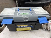 Closed gray plastic toolbox with blue latches and a handle, 10-inch size.