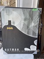 Full view of Batman vinyl print showing Batman with cape and city background along with text.