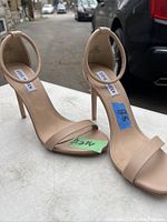 Photo shows a single beige/nude open-toe high heel shoe with ankle strap and stiletto heel, labeled with size 8.5 and brand Steve Madden.