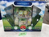 Front view of sealed Pokemon Trading Card Game Alolan Exeggutor V collector's set box containing plush, promo card, and booster packs.