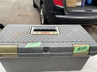 Closed Rubbermaid toolbox dark gray plastic with metal latch and black handle, labeled #210