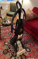Front view of Bissell ProHeat carpet cleaner showing height and hose attached to the side.