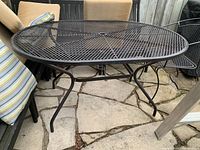 Side view of table showing curved legs and mesh tabletop