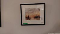 Framed watercolour painting hung on wall, showing the landscape scene and signature.