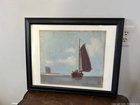 Framed pastel painting showing maritime scene with sailboat and calm sea.