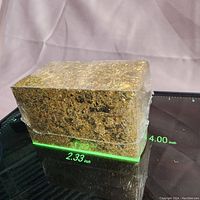 Single clear plastic box filled with gold leaf flakes shown with measurements (4.00 inches length, 2.33 inches width).