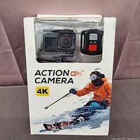 Front view of the product box showing the camera and remote control through the window, highlighting 4K action camera with WiFi.