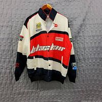 Front view of Blackair retro racing jacket showing red, black, and white color block with brand logos embroidered on chest and sleeve