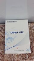 Box cover showing product name Health Smart Bracelet Smart Life with tagline.