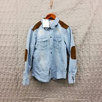 Photo showing men's light blue long sleeve shirt with brown elbow and shoulder patches, size M, new with tags.