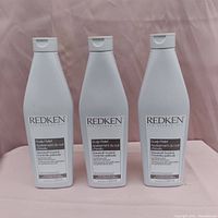 Photo of three bottles of Redken Scalp Relief Dandruff Control shampoo each 300 ml.
