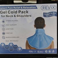 Photo of the packaging of a Revix Gel Cold Pack showing usage for neck and shoulders with benefits like sports injuries, post-surgery, joint pain, first aid, and muscle swelling. Blue colored cold pack shown fitted on a model's neck and shoulders.