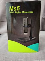 Photo of the product box showing the Ms5 Wi-Fi Digital Microscope with image of the microscope and stand on the front.