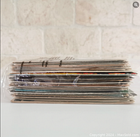 Side view of postcard stack showing thickness and quantity.