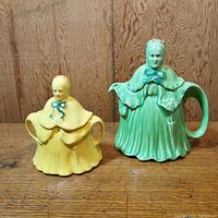 Photo showing the pair of ceramic little old lady teapot and sugar bowl, green and yellow color visible.