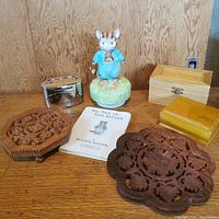 Overview of all items in the lot on wooden surface and wood paneled backdrop.