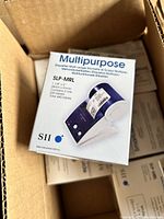 Box containing multiple stacked boxes of SII Multipurpose Label Maker Stickers with dimensions and quantities labeled, showing front packaging with product image.