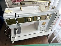 Photo of the full Elna Golden Jubilee electronic sewing machine showing front, top handle, and control panel.