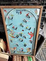 Front view of the vintage 1950's POOSH-M-UP Big 5 pinball game showing playfield with baseball-themed graphics, scoring holes, and wooden frame.