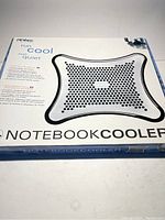 Box and front view of Antec Notebook Cooler showing product image, brand, and slogan 'run cool run quiet'.