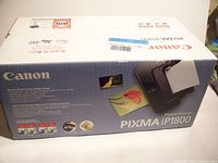 Box of Canon PIXMA iP1800 sealed new printer, showing front with product image and branding.