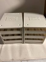 Two white Spice Stack spice drawer units stacked side by side, each with closed drawers and the brand logo on top.