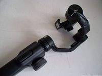 Image showing the whole stabilizer gimbal with clamp for mounting a camera or smartphone.