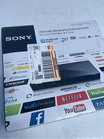 Front of unopened Sony Blu-ray player box showing various streaming app logos and 'Ultimate Streaming Entertainment' branding.