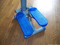 Close-up photo of blue textured foot pedals on the stepper machine base