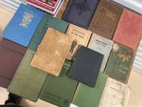 Overview of 12 assorted antique/vintage religious books arranged side by side showing cover colors, titles, and wear