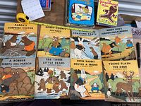 Set of 8 Thornton Burgess children's booklets laid out with titles visible.
