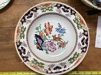 Top view of the Minton dinner bowl showcasing vibrant floral and bird painted design with ornate relief border.