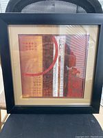 Front view of the framed abstract painting "Nan" showing the details of the geometric artwork and black frame.