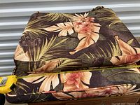 Outdoor cushions stacked with measuring tape showing length of approximately 20 inches