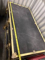 Top view of closed trunk with tape measure across length