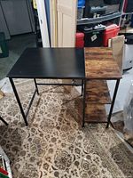 Photo showing the full desk with a half black and half rustic wood top and three side shelves.