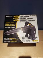 Front of box showing the BONAIRE Shop Blower with specifications such as 120 volts power, powerful air flow of 222 km/h or 138 mph, lightweight and easy to use.