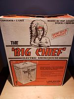 Original packaging box of Big Chief Electric Smokehouse Model BC Top Loading with artwork featuring a Native American chief and product details.