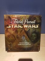 Front box image showing the Trivial Pursuit Star Wars Classic Trilogy Collector's Edition sealed in plastic wrap